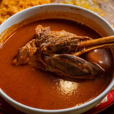 Borrego lamb shank served in rich red broth.