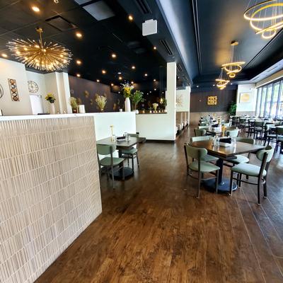 Interior featuring dark ceilings, warm wood flooring, and contemporary pendant lighting.