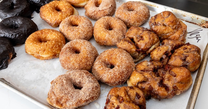 Variety of fresh donuts on a baking sheet