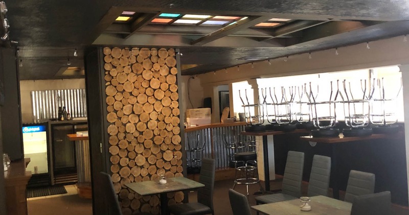 Interior with wood details and chairs turned upside-down