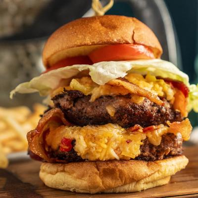 Pimento Cheese Bacon Burger, with lettuce and tomatoes.