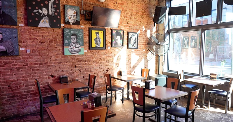 Interior, brick wall decorated with paintings and seating space