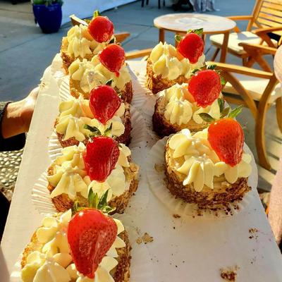 A tray of desserts topped with fresh strawberries.