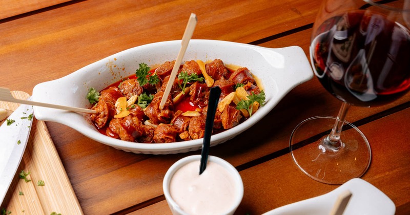 Sausage with wine reduction and a glass of red wine