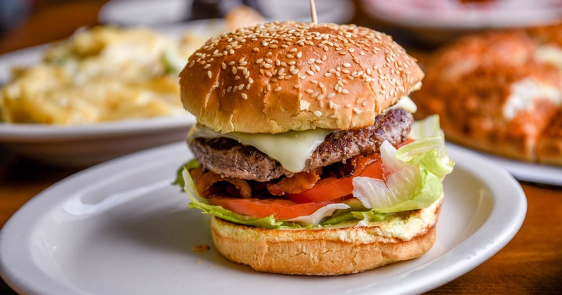 A cheeseburger on a sesame bun