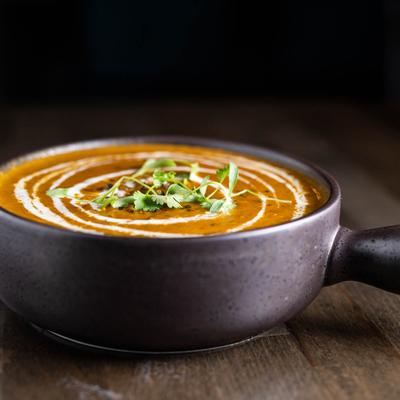 Slow cooked black lentils with butter, drizzled with cream