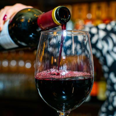 Wine being poured from the bottle into a glass.