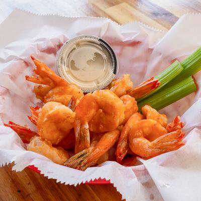 Sauced shrimp served with celery and dipping sauce.