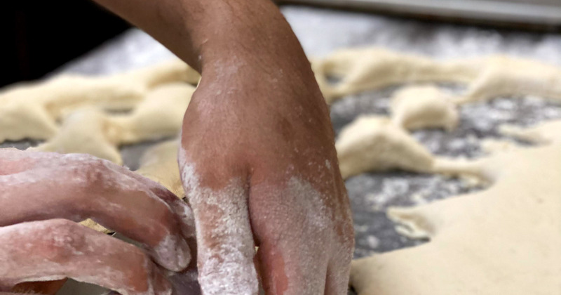 Chef's hands working with dough