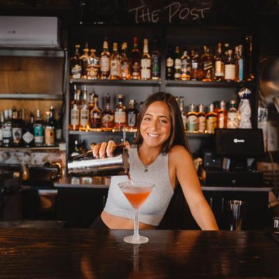 Bartender pouring a Cosmopolitan cocktail