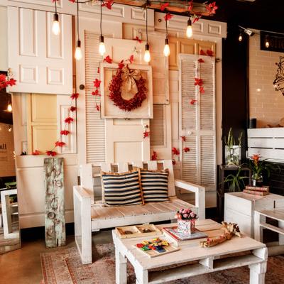 Lounge area with rustic wooden furniture, decorations and hanging lights.