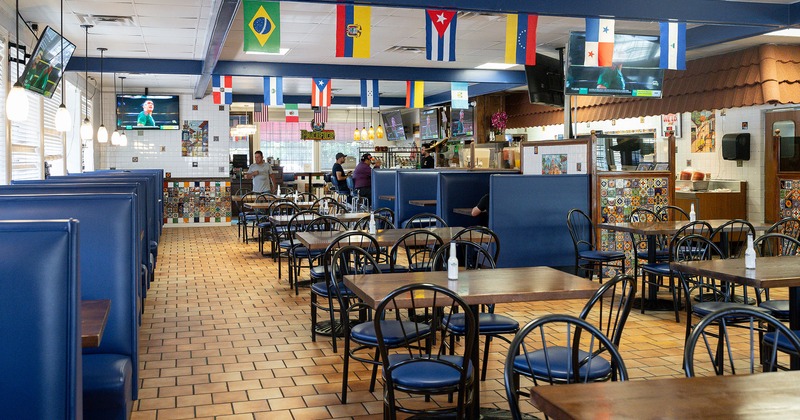 Restaurant interior, dining area with tables, chairs and booths