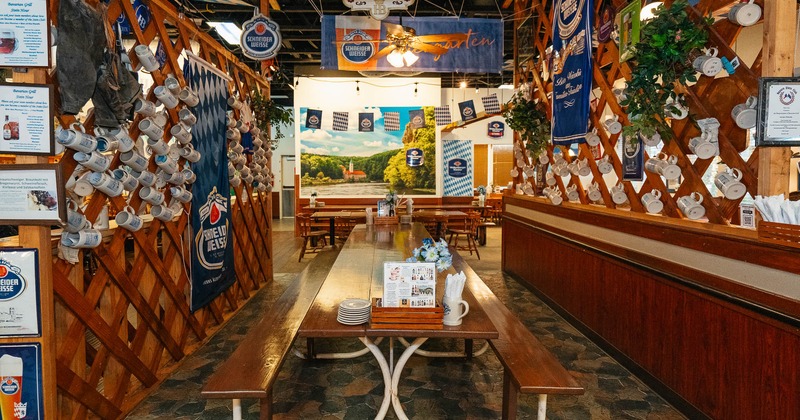 Interior, a long wooden table with tableware and bench seating
