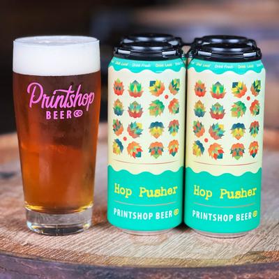 Cans and glass of Hop Pusher beer.