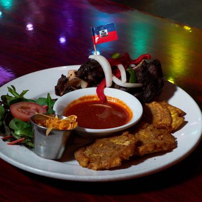 Beef, salad, mofongo, and sauce.