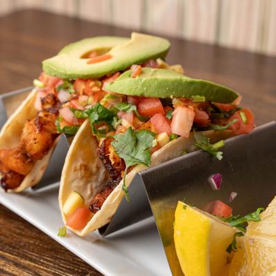 Grilled fish tacos with avocado and salsa.