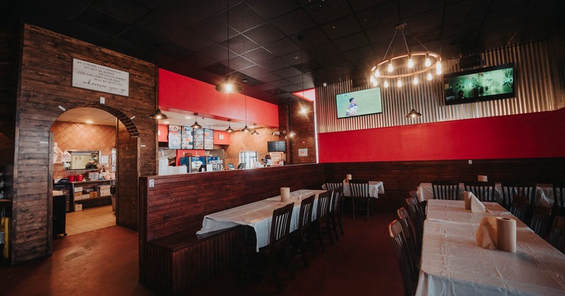 Interior, chairs and tables, TV's on the wall