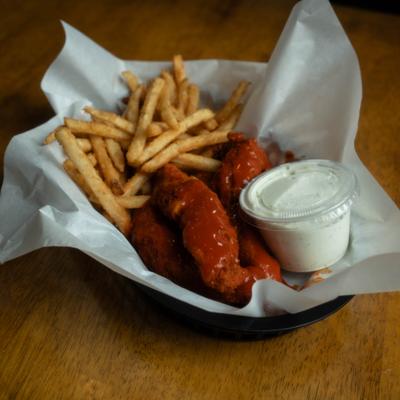 Sauced chicken tenders with fries and ranch dip in a basket.