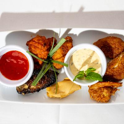 Combination platter featuring a variety of fried items and dips, overhead view.