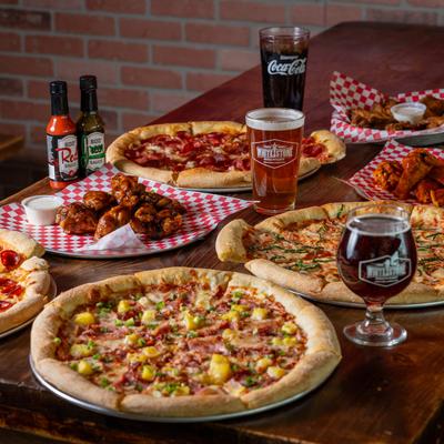 Various served pizzas with drinks.