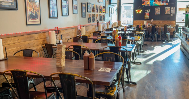 Interior, wooden tables and black chairs, condiments on the tables, decoration