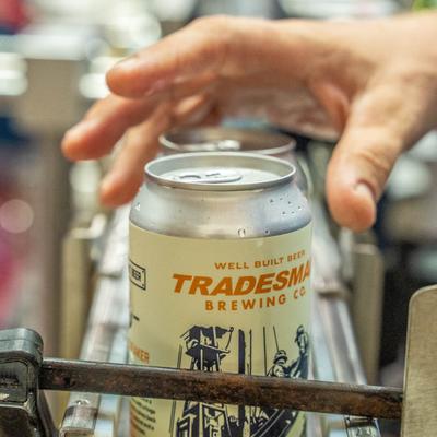 A hand and a can of Circuit Breaker, close up.