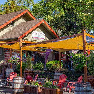 View of the restaurant entrance with signage and outdoor patio.