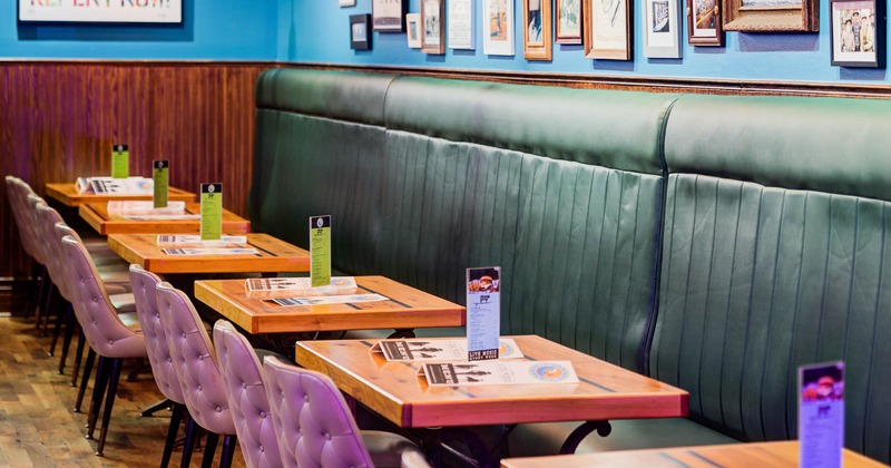Seating area with tables, walls decorated with framed pictures