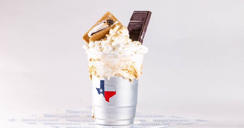 Vanilla shake garnished with a chocolate bar and cracker