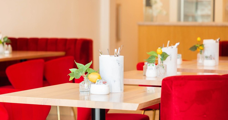 Interior, table with decorative leaves and lemons and red chairs