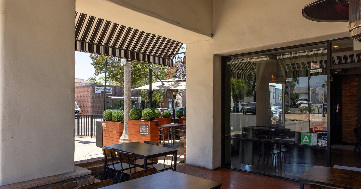 Covered outdoor seating area in front of the restaurant entrance