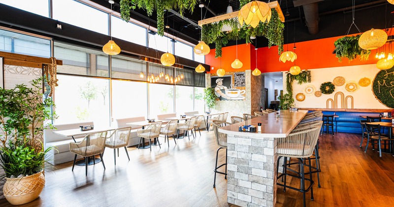 Tables lined up by the large windows.