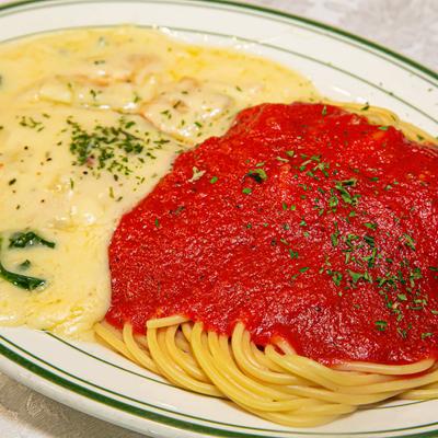 Chicken smothered in cheese sauce, with spaghetti in marinara sauce.