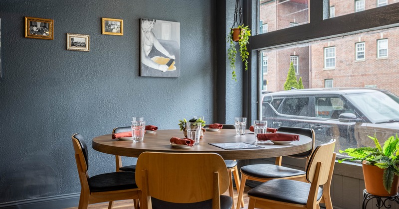 A cozy dining area with a round wooden table set for four
