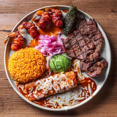 Little Mexico plate with rib-eye steak, cheese enchilada, shrimps and sides.