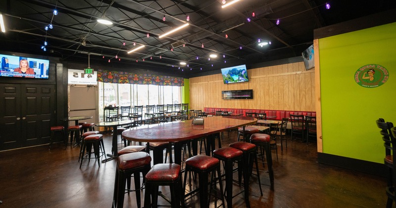 Dining space with tall tables and bar stools