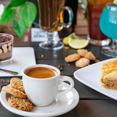 Cup of coffee served with various sweets