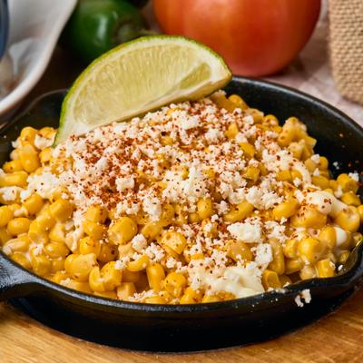Mexican street corn off the cob topped with mayo, queso, and chili powder.