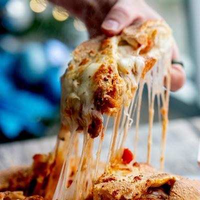 Large Chicken Parmesan Calzone, cheese pull shot.