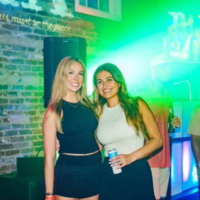 Two guests standing and smiling.