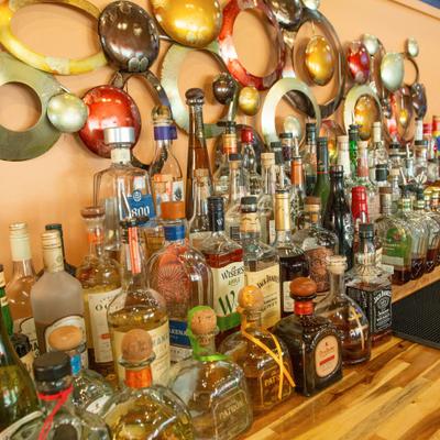 Liquor bottles arranged on a wooden bar counter.
