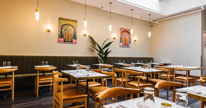 Interior, a dining tables with chairs and paintings on the wall