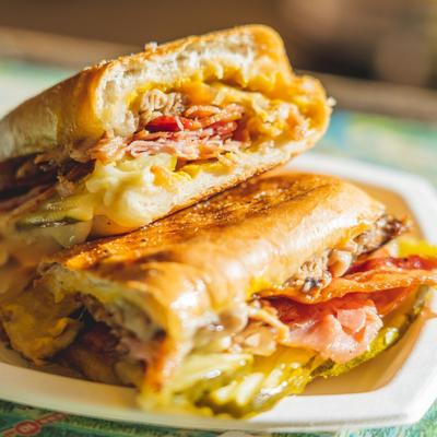 Cuban sandwich with pulled pork, ham, and pickles.