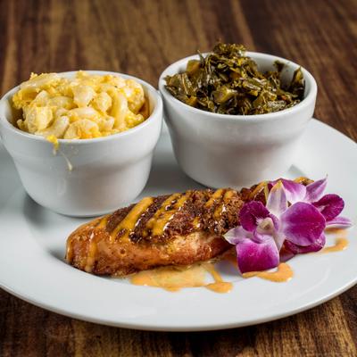 Stuffed Salmon served with sides of mac and cheese and collard greens.