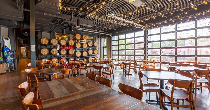Interior, tables and chairs, wood barrels on racks