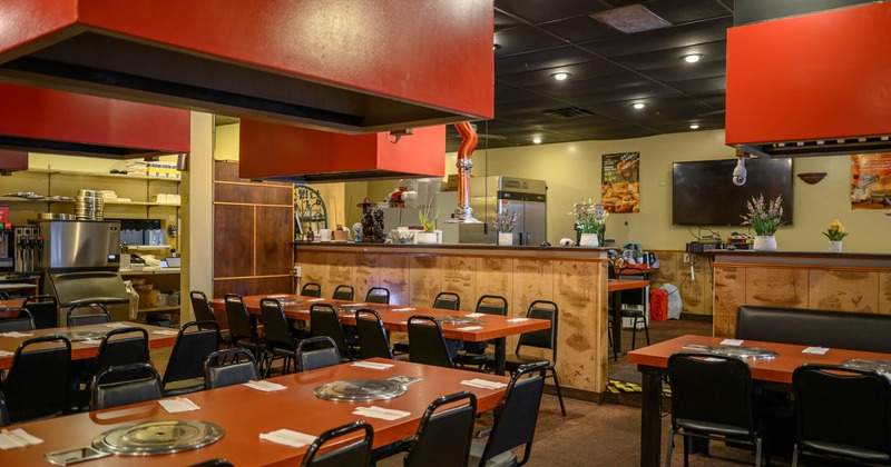 Interior seating area with tables, chairs and built-in tabletop grills