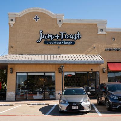 Restaurant's entrance with a sign, street view.