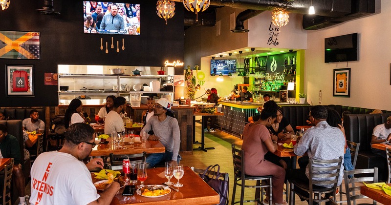 Dining area, with guest eating, wide view, tv's above