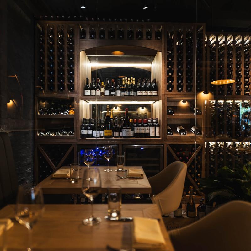 Interior, tables and chairs, wine rack in the back