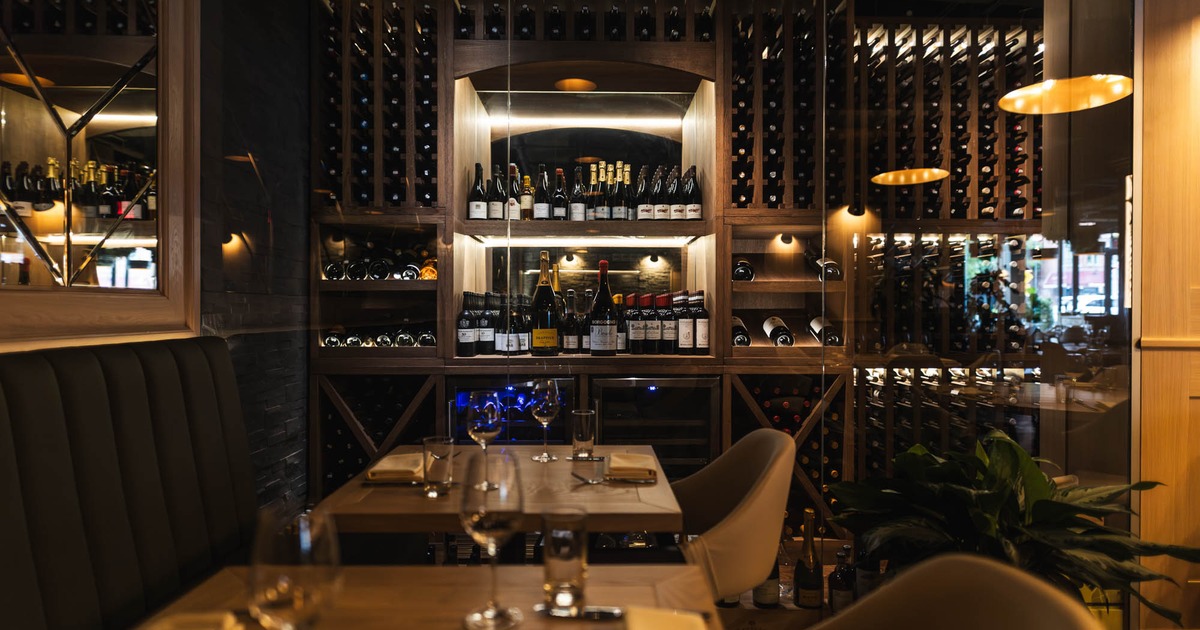 Interior, tables and chairs, wine rack in the back